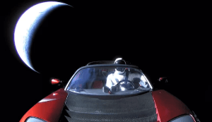 An image of Tesla's red Roadster in orbit, empty astronaut suit at the wheel