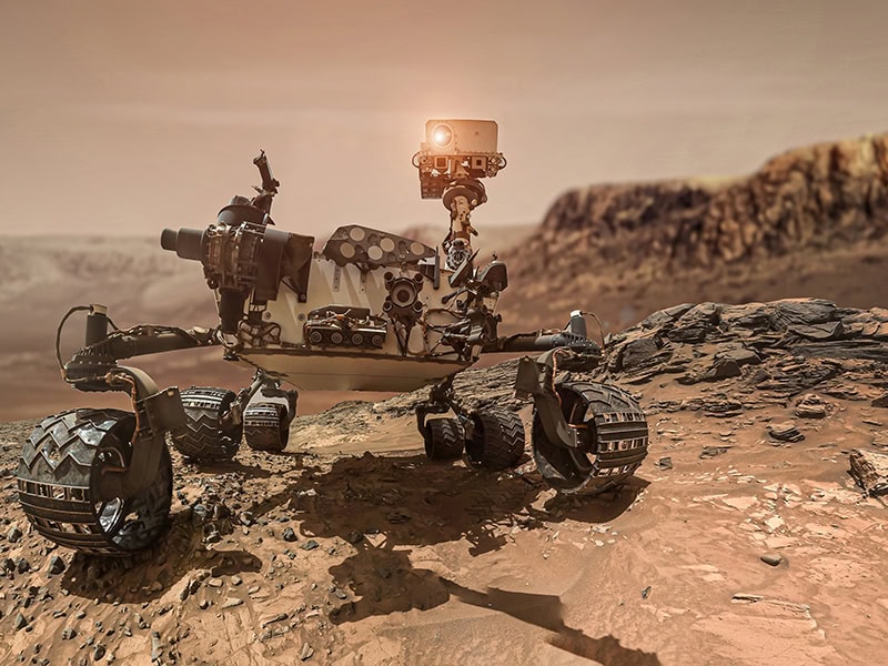 Robotic Mars rover exploring the Martian surface with advanced sensors and rugged wheels in a dusty, rocky landscape.